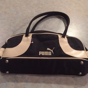 Puma black and cream colored fabric purse.